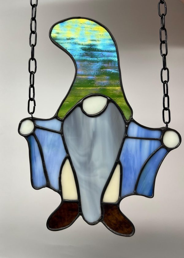 Naughty flashing gnome stained glass. green hat, gray beard, blue coat.