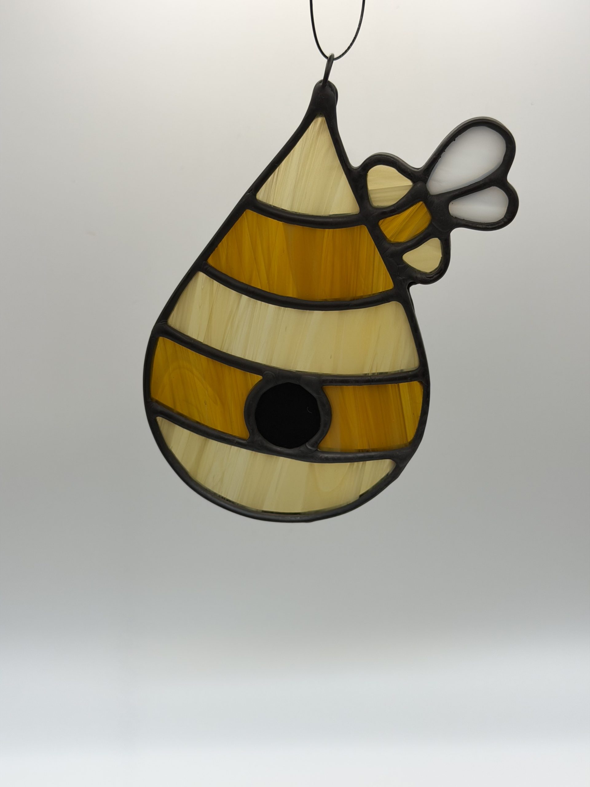 amber and dark amber striped bee hive sun catcher.