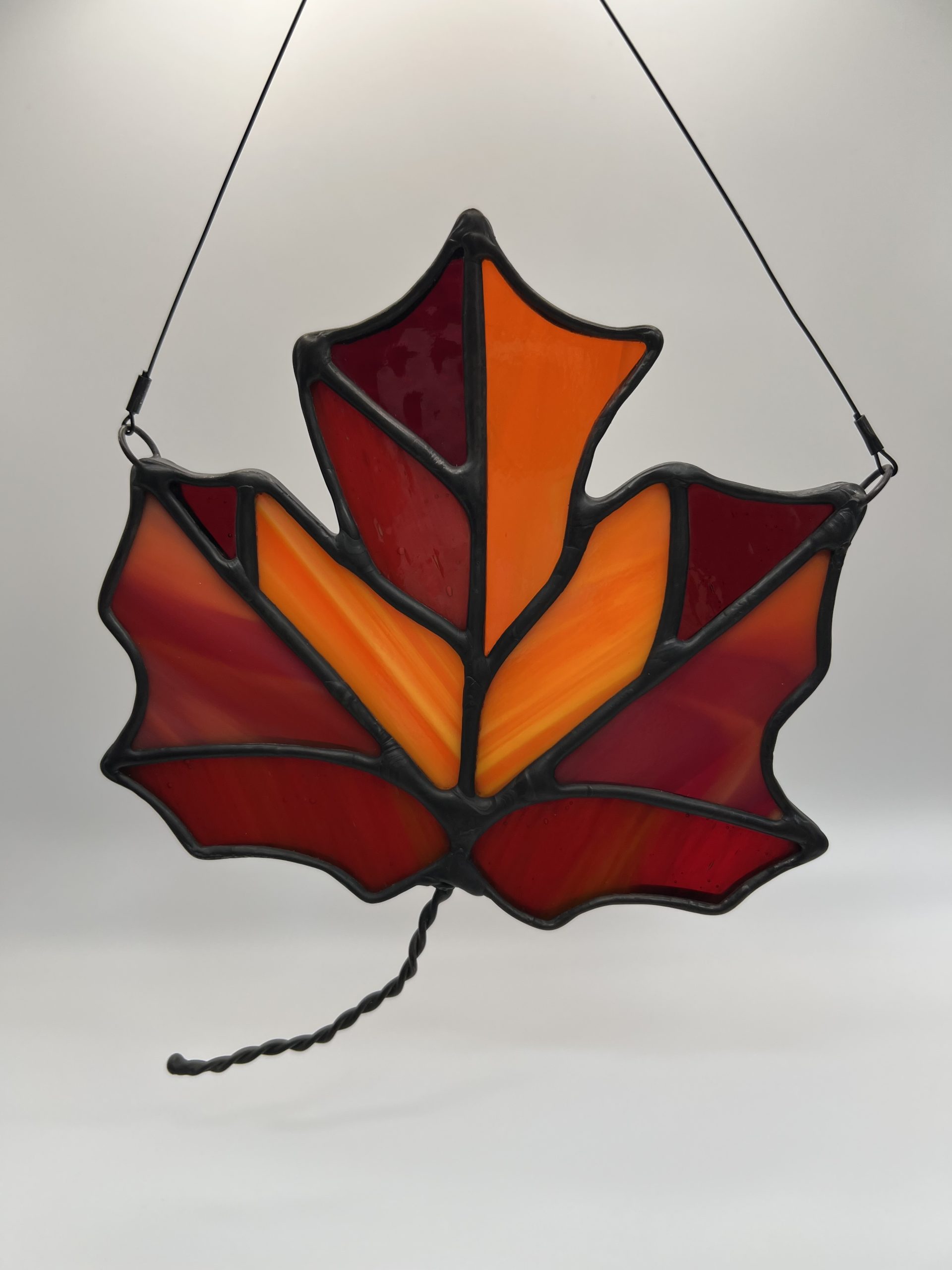 orange and red maple leaf stained glass sun catcher